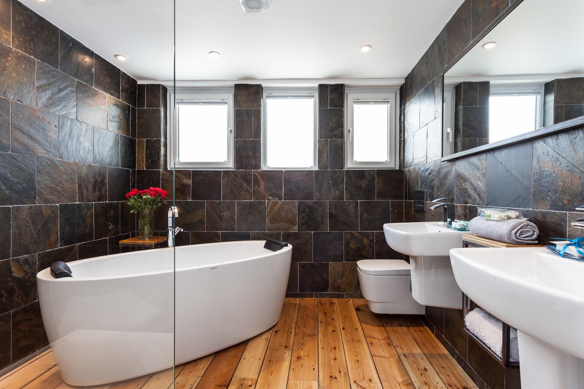The stunning bathroom with a freestanding bath is a luxurious place to pamper yourself before heading out to explore St Ives.