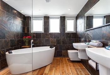 The stunning bathroom with a freestanding bath is a luxurious place to pamper yourself before heading out to explore St Ives.