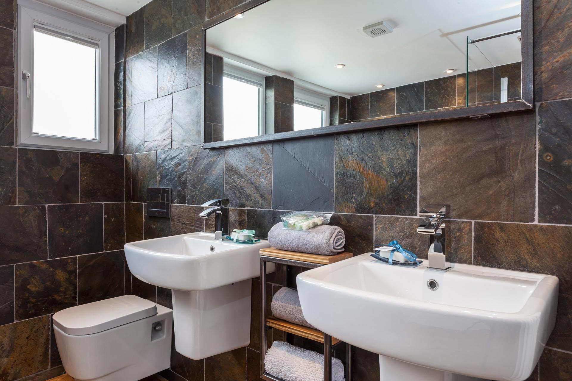 The bathroom is beautifully designed, offering a spa-like feel.