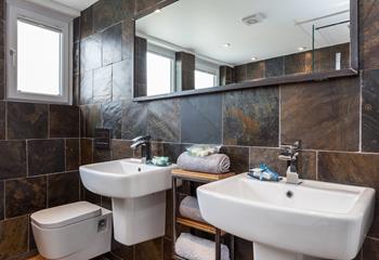 The bathroom is beautifully designed, offering a spa-like feel.
