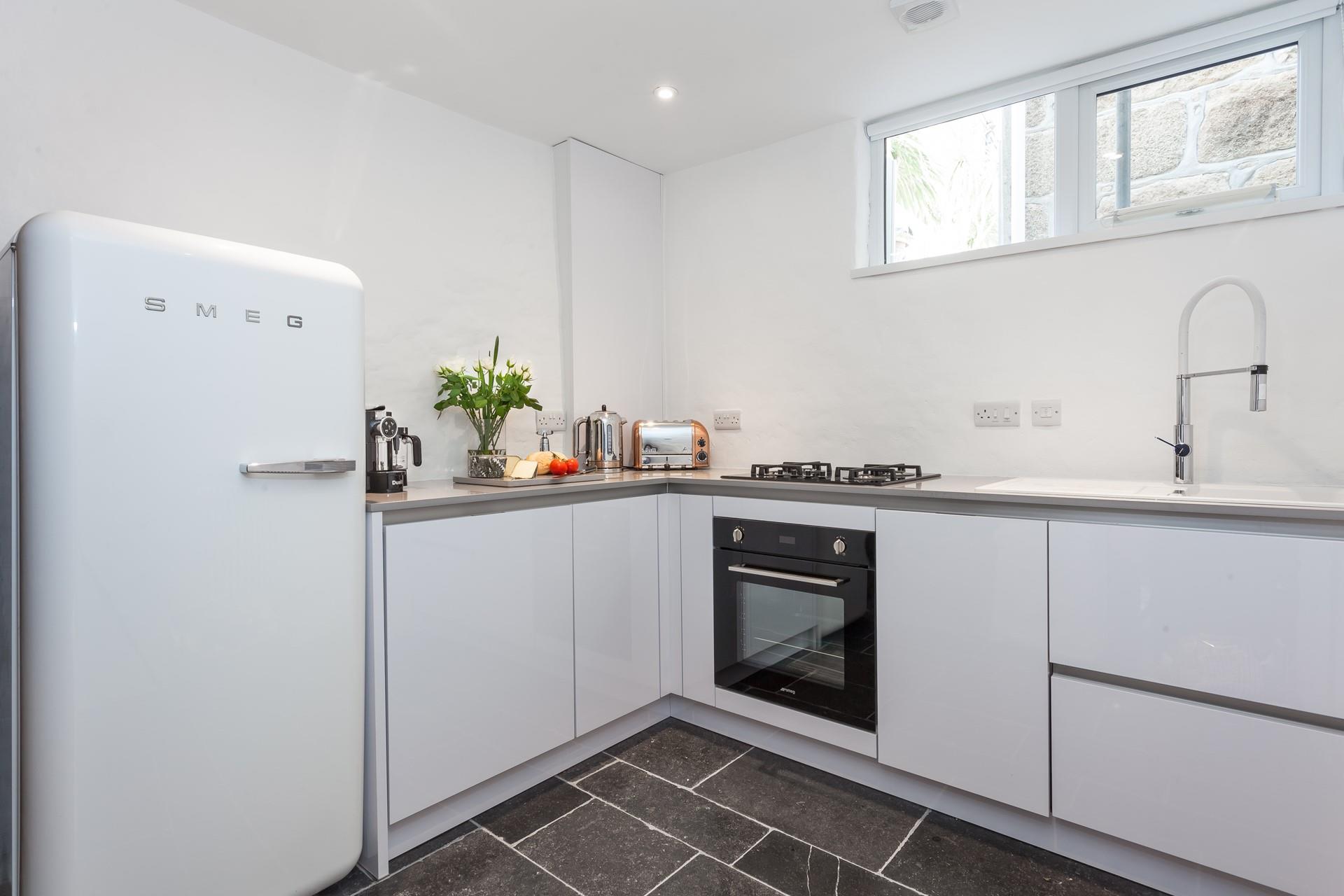 The kitchen has been beautifully designed and is well-equipped with modern appliances to make home cooking a breeze.