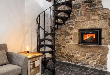 A modern wood burner with exposed stone walls creates a cosy and calming ambience, perfect for snuggly nights in.