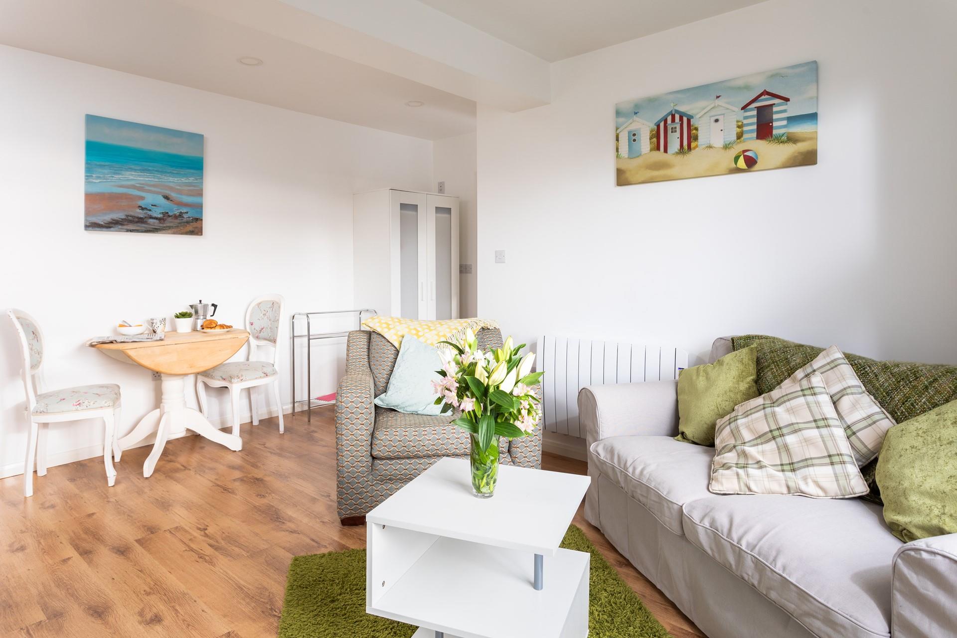 The comfortable sitting/dining area is great for relaxing with a book or a good film. 