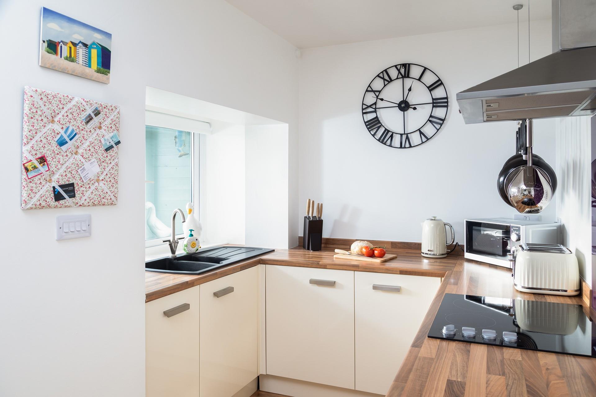 The large window provides plenty of natural light, making the kitchen a bright and airy space.
