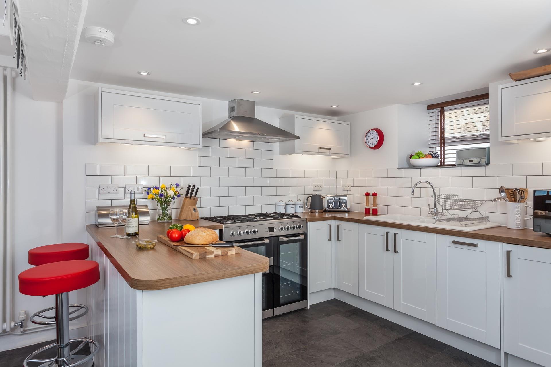 The lovely, modern kitchen area is well-equipped to cook delicious meals.