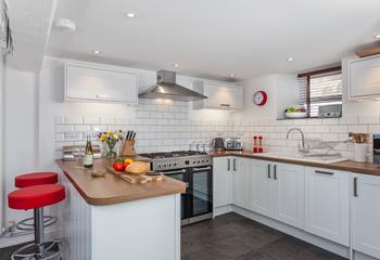 The lovely, modern kitchen area is well-equipped to cook delicious meals.