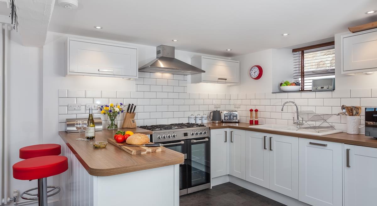 The lovely, modern kitchen area is well-equipped to cook delicious meals.