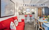 The kitchen/ dining room features a bright sofa and a breakfast bar, space for everyone to have a hearty breakfast. - Thumbnail Image
