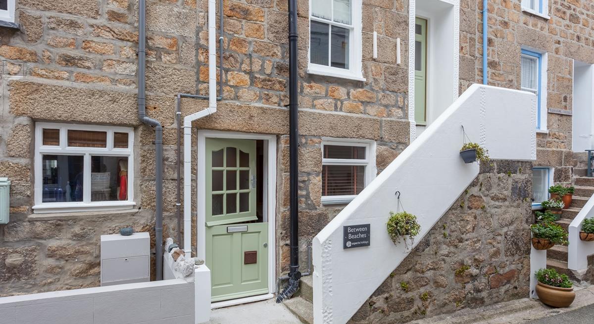 The front of the property. It has a front door on the ground floor, as well as an entrance on the first floor.