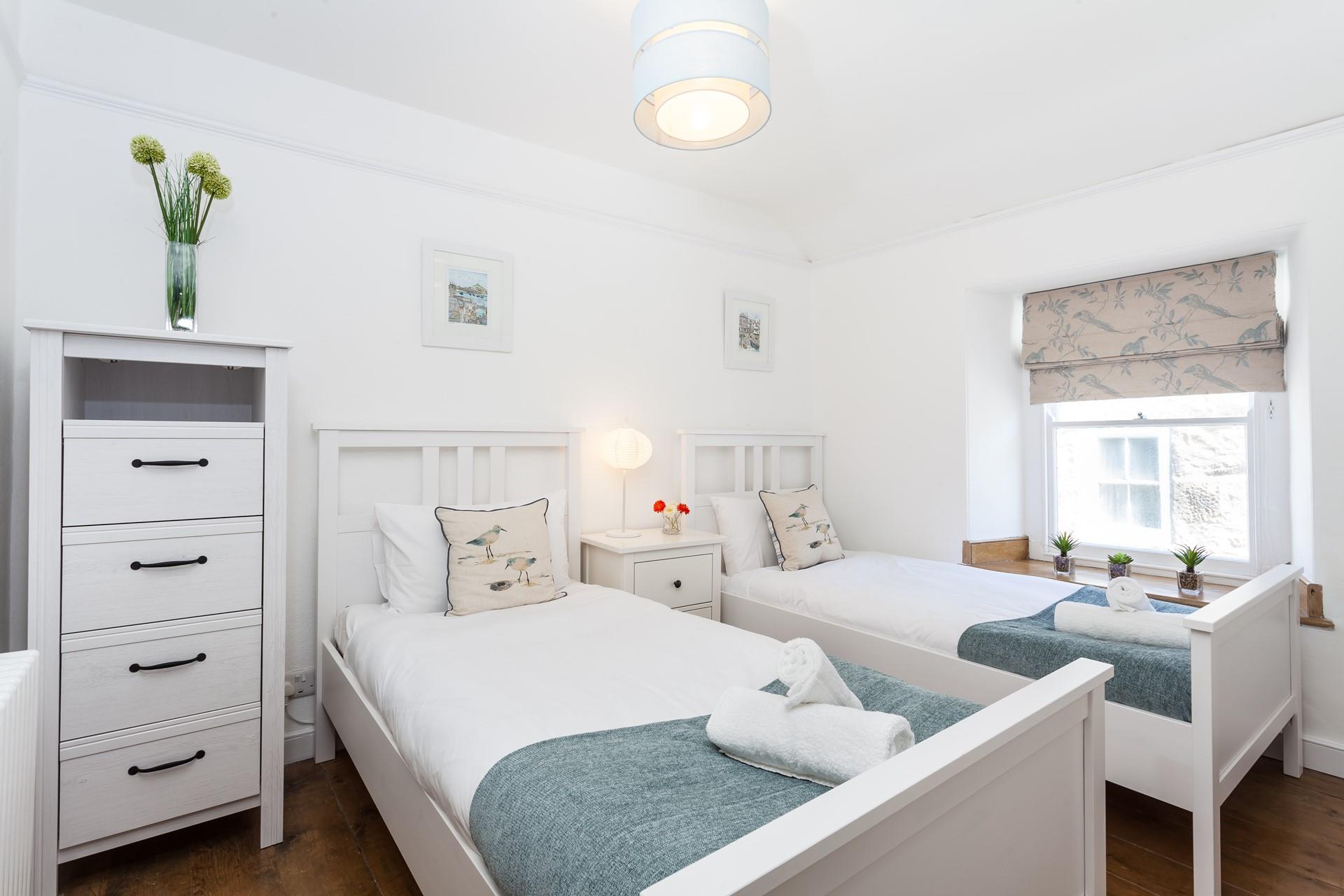 The serene twin bedroom is great for kids of adults.