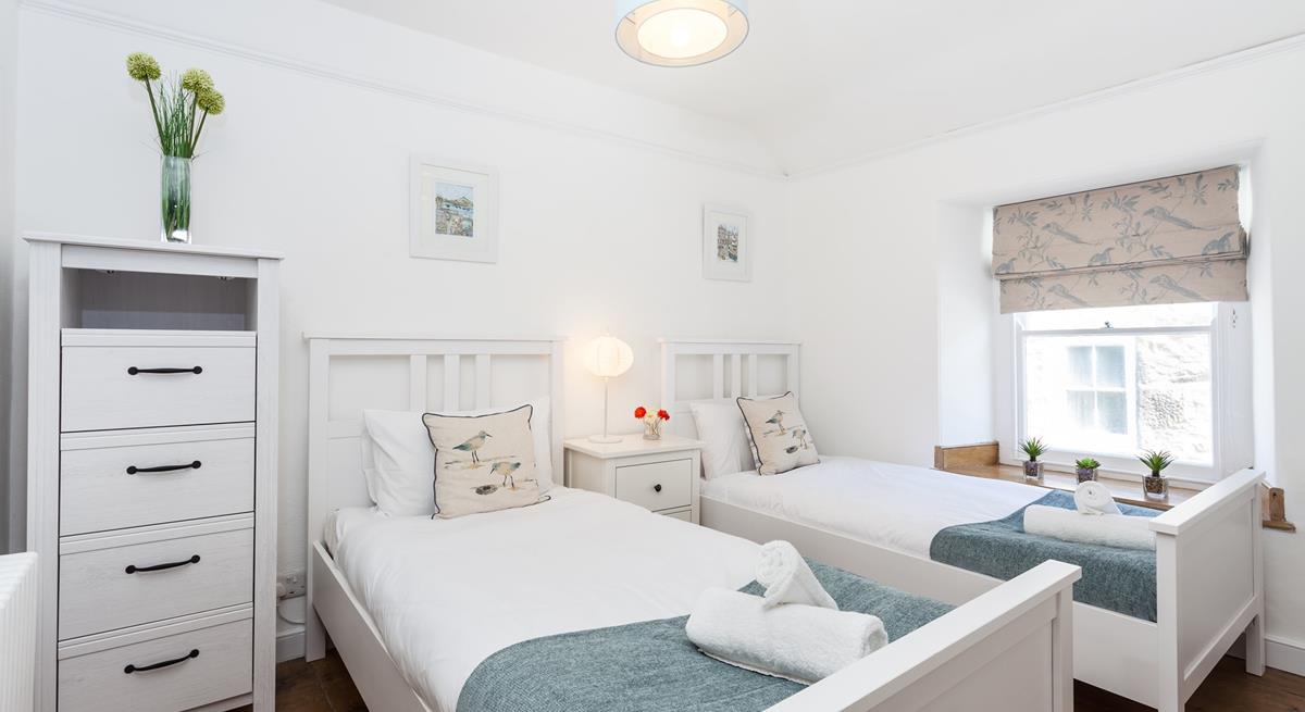 The serene twin bedroom is great for kids of adults.
