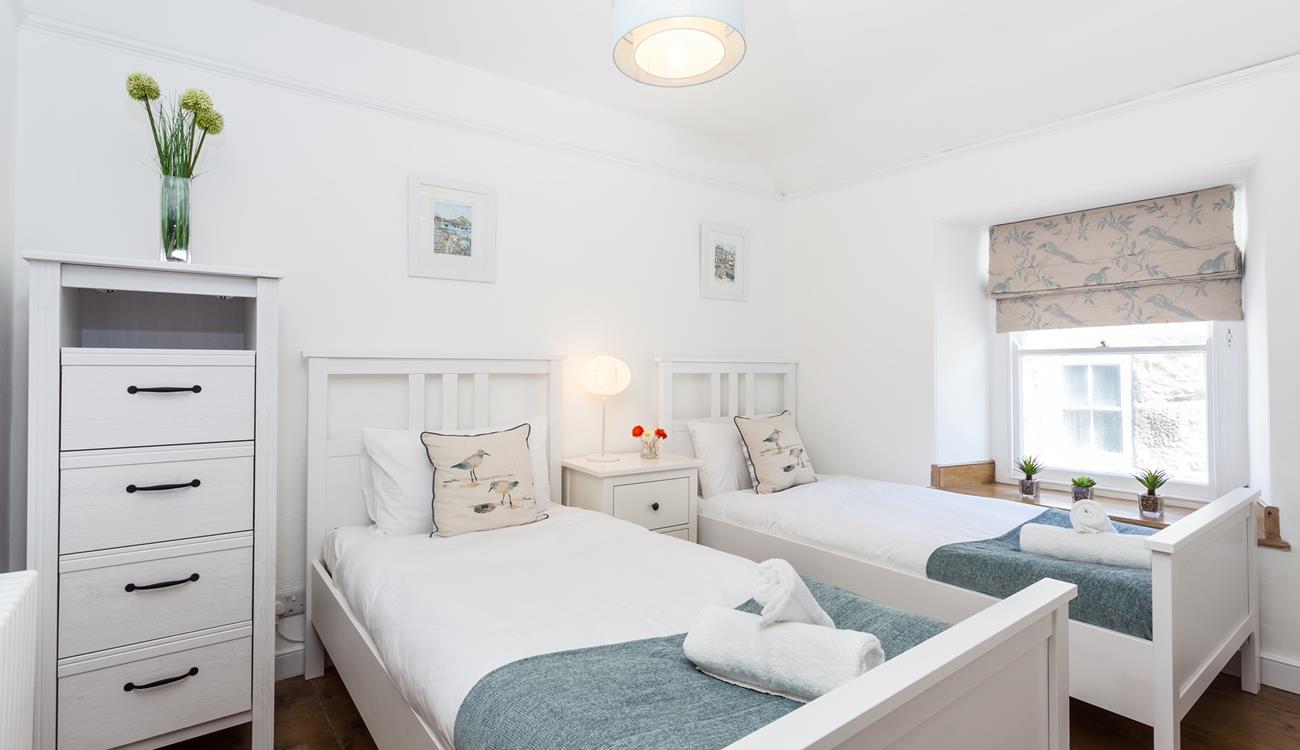 The serene twin bedroom is great for kids of adults.