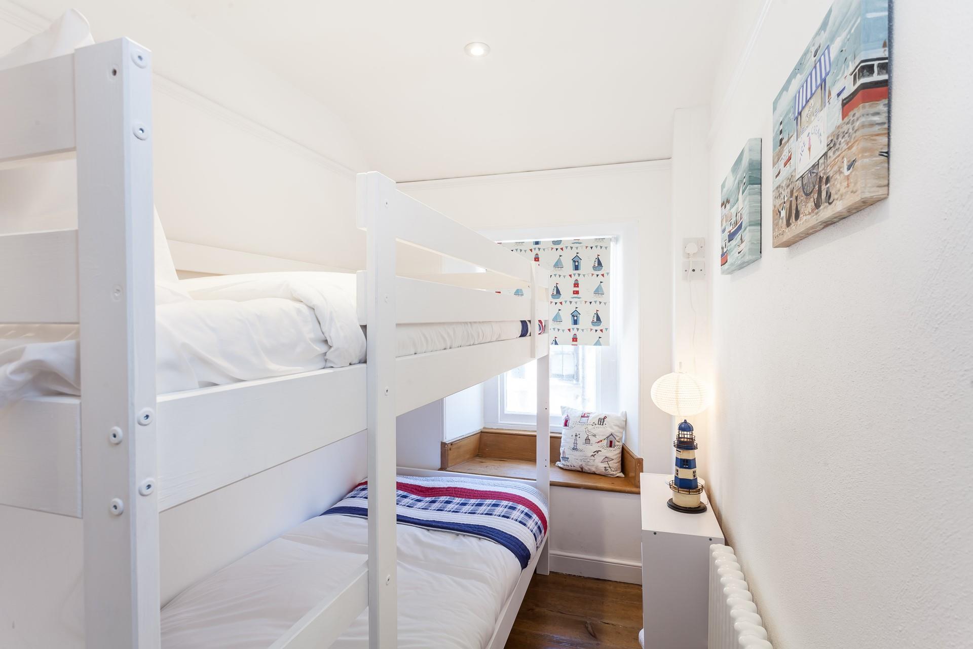 Settle the kids into the bunk beds and open a bottle of wine to sip in the cosy sitting room.