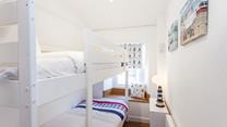 Settle the kids into the bunk beds and open a bottle of wine to sip in the cosy sitting room.