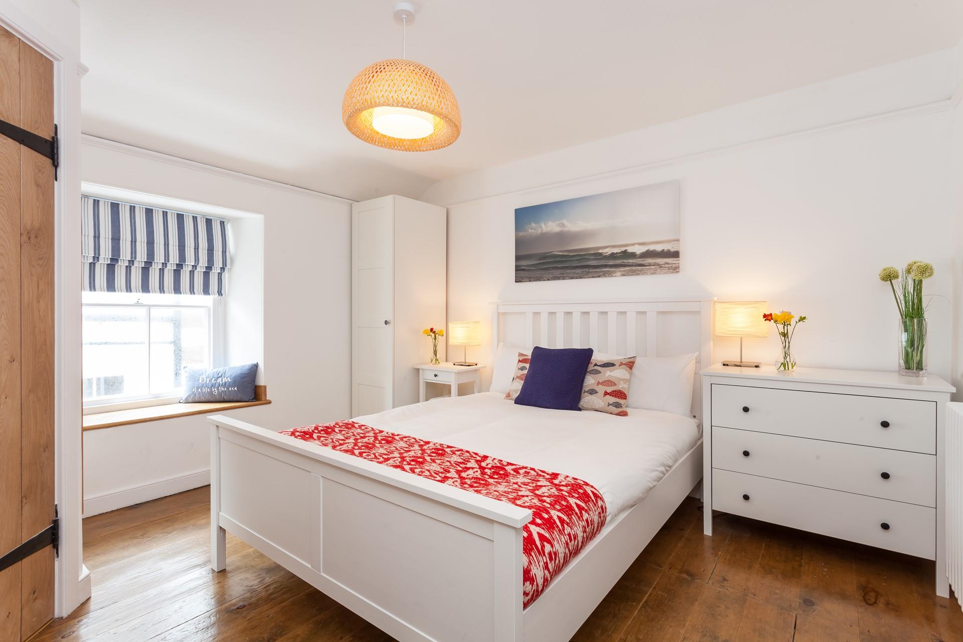 Bedroom 4 is located on the 2nd floor and features blue and red interiors providing you with a cosy base to rest your head.