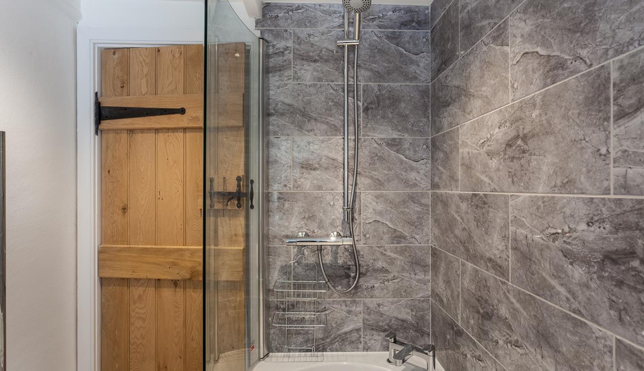 Wash off the sand in the shower after a sunny beach day.