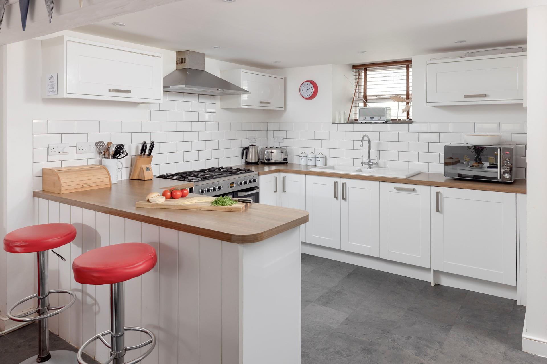 The lovely, modern kitchen area is well-equipped to cook delicious meals.