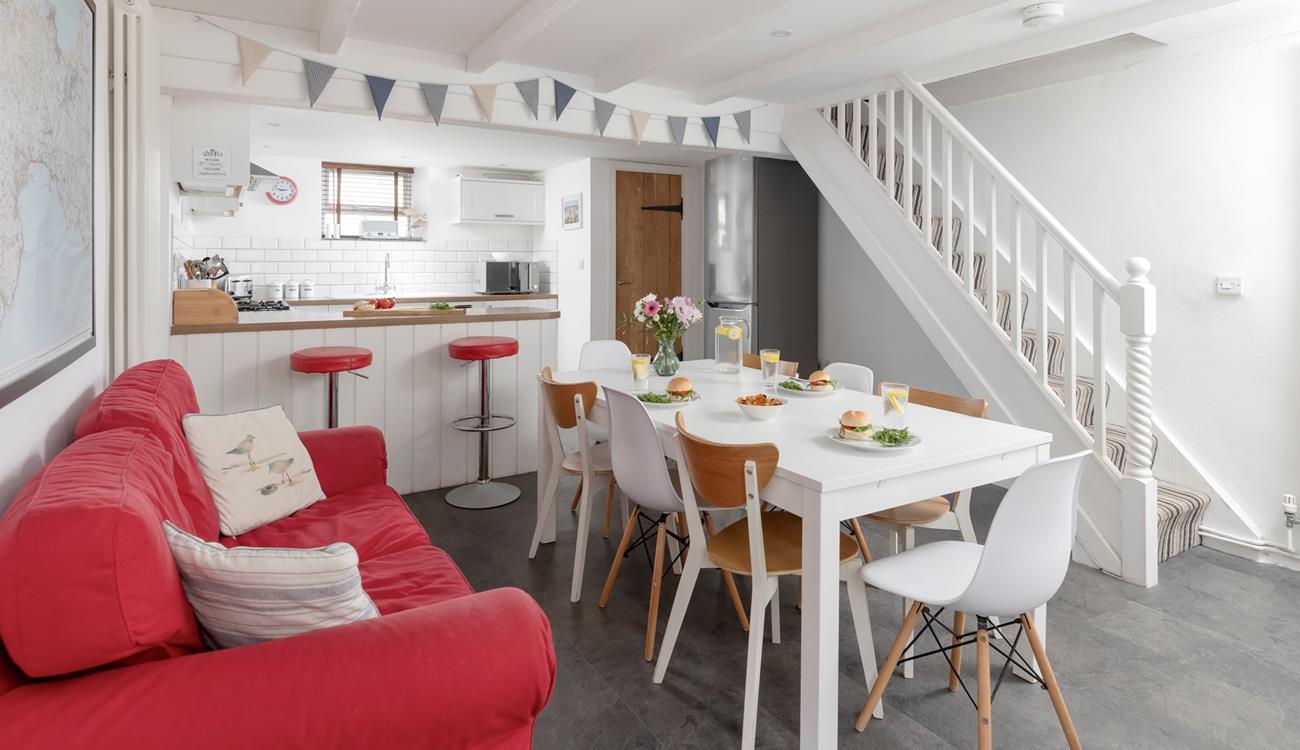 The kitchen/ dining room features a bright sofa and a breakfast bar, space for everyone to have a hearty breakfast.
