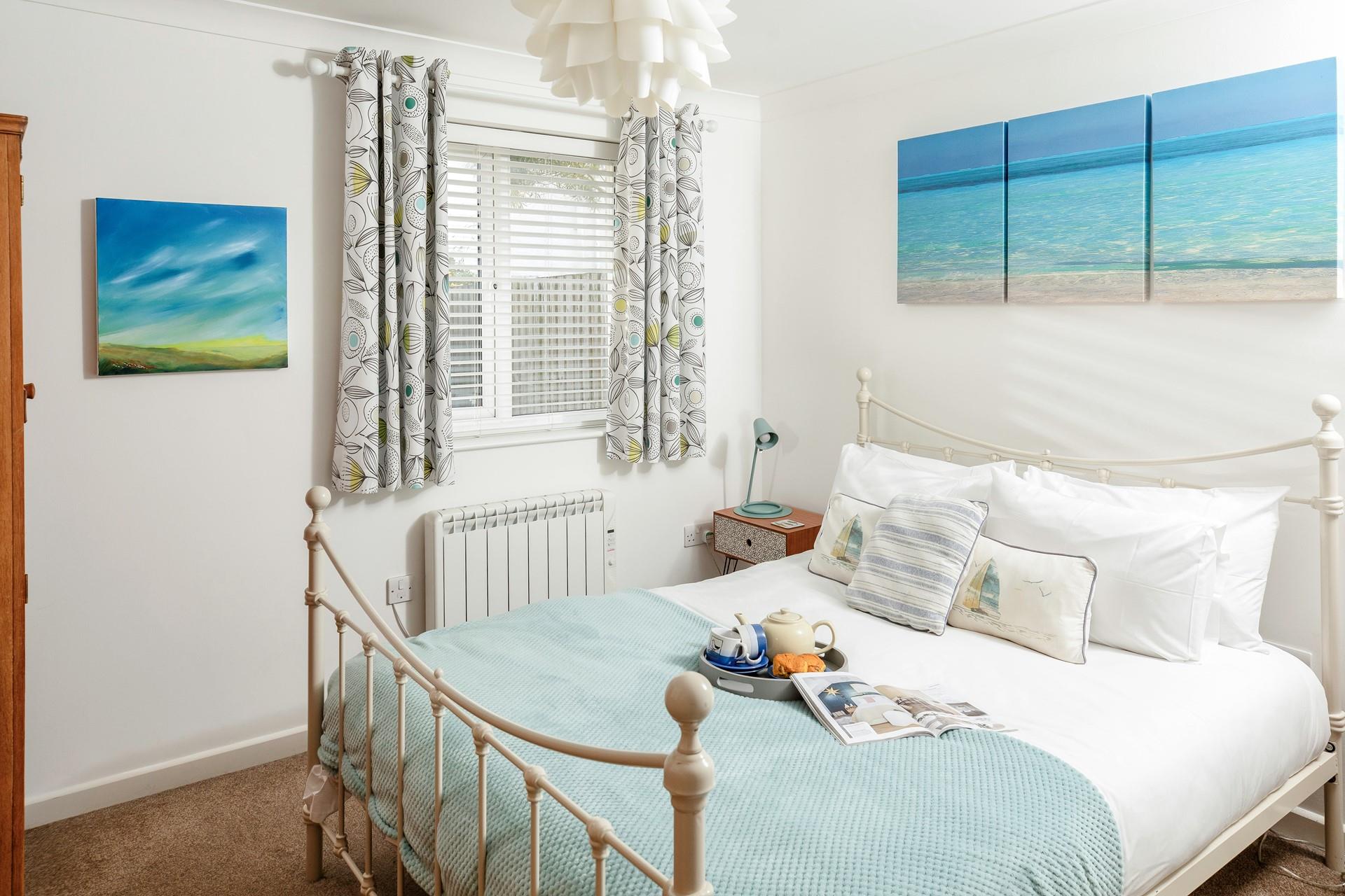 Bedroom 1 is decorated in a distinctly seaside style reminding you just how close to the sea you are!