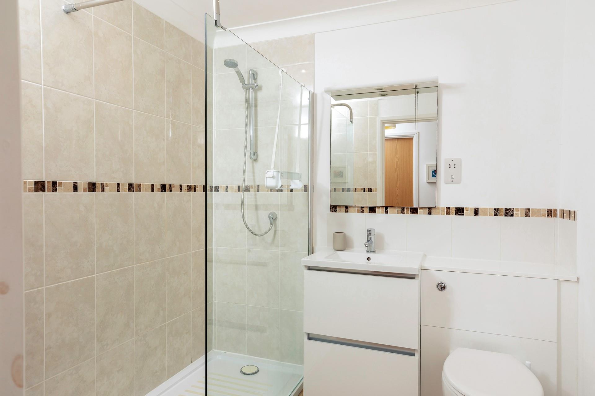 The shower room has a spacious walk-in shower, perfect for an invigorating, luxury start to your day.