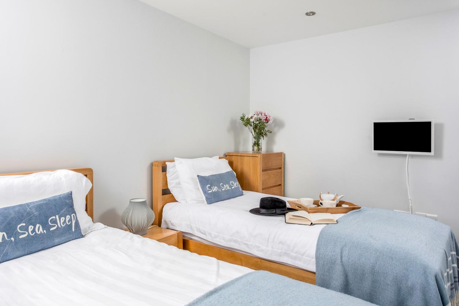 Bedroom 2 is tastefully decorated in calming blue tones.
