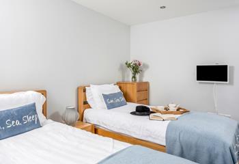 Bedroom 2 is tastefully decorated in calming blue tones.