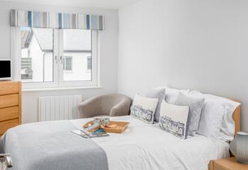 Soft sheets and fresh towels await in bedroom 1.