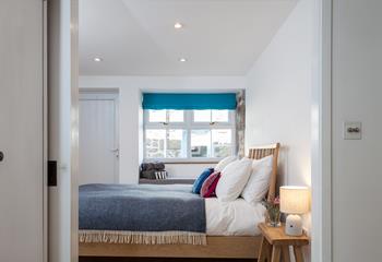 Large windows ensure the bedroom is a bright and airy space.