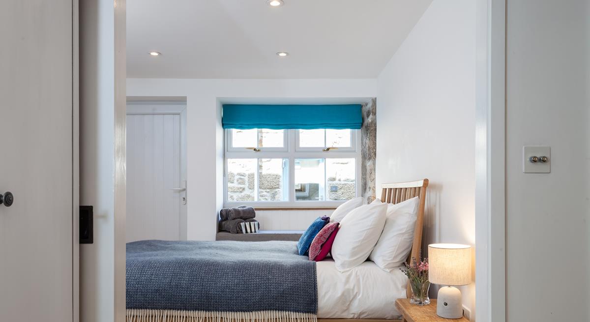 Large windows ensure the bedroom is a bright and airy space.