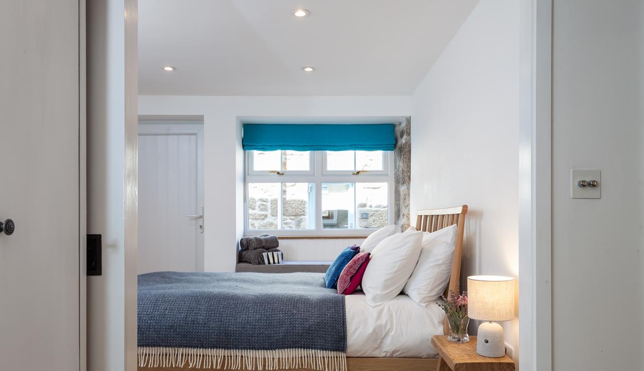 Large windows ensure the bedroom is a bright and airy space.