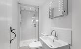 Freshen up before a night out in the chic, minimalist bathroom. - Thumbnail Image