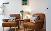 Cosy armchairs offer the perfect spot to snuggle down with a good book and a cup of tea. - Thumbnail Image