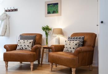 Cosy armchairs offer the perfect spot to snuggle down with a good book and a cup of tea.