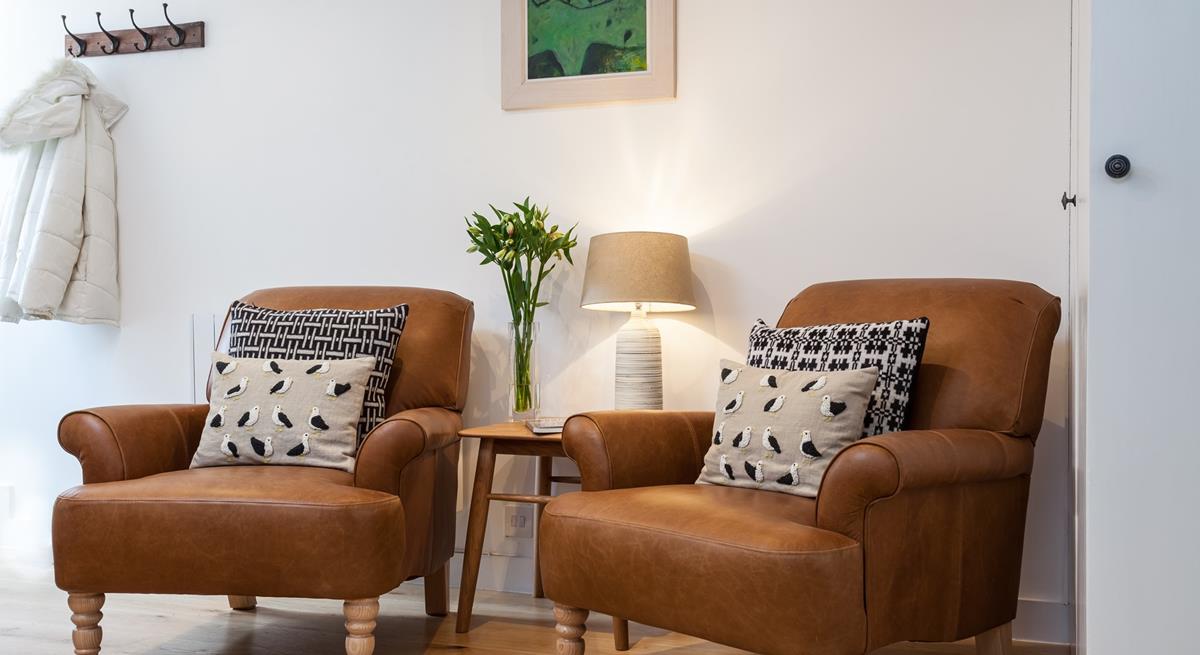 Cosy armchairs offer the perfect spot to snuggle down with a good book and a cup of tea.