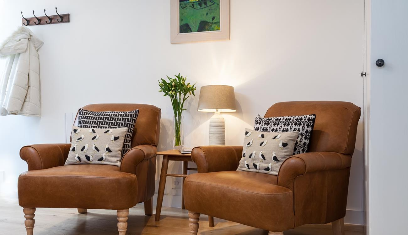 Cosy armchairs offer the perfect spot to snuggle down with a good book and a cup of tea.