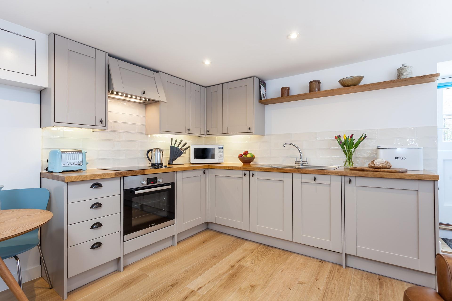 The kitchen's sleek design is sure to delight any budding chef. 