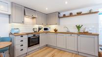 The kitchen's sleek design is sure to delight any budding chef. 