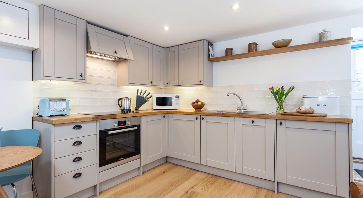 The kitchen's sleek design is sure to delight any budding chef. 