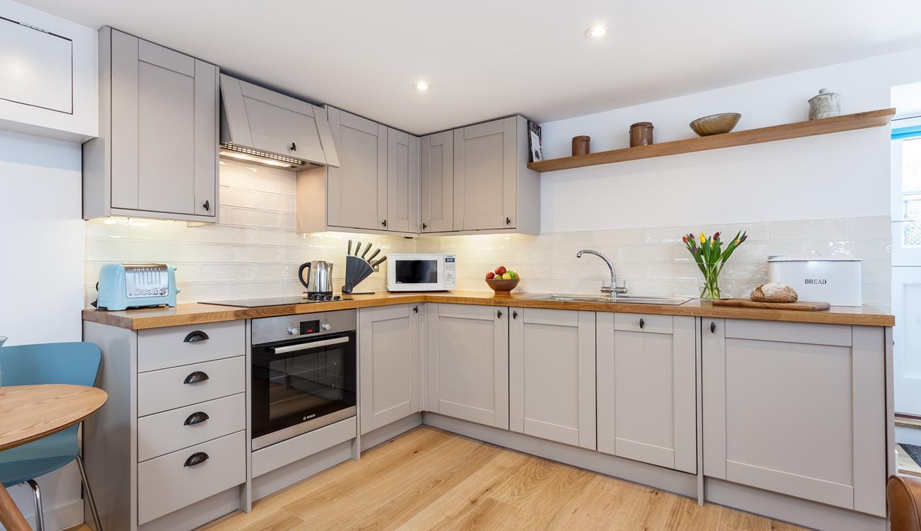 The kitchen's sleek design is sure to delight any budding chef. 