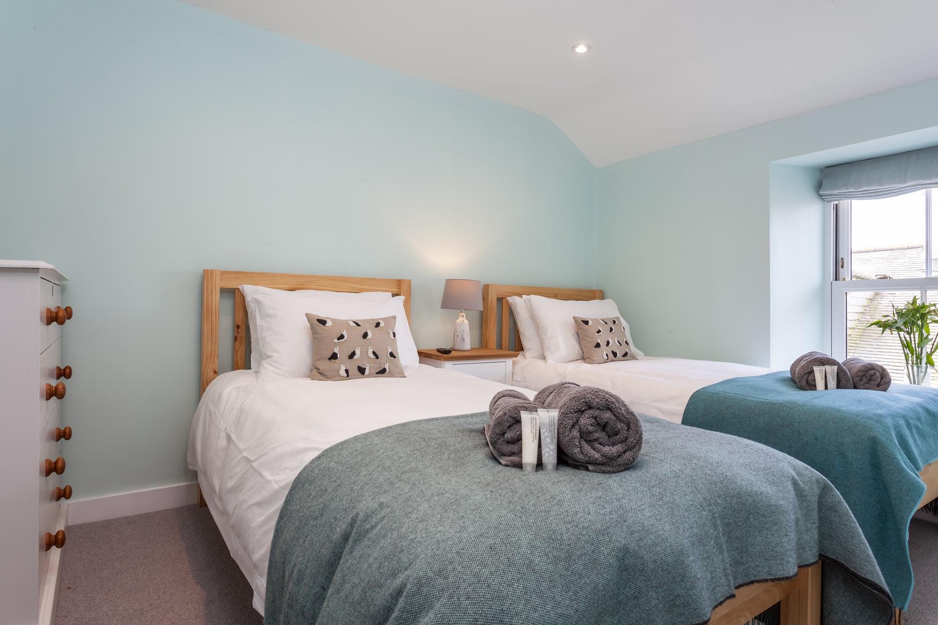 Bedroom 2 has comfortable twin beds perfect for young adults or children.