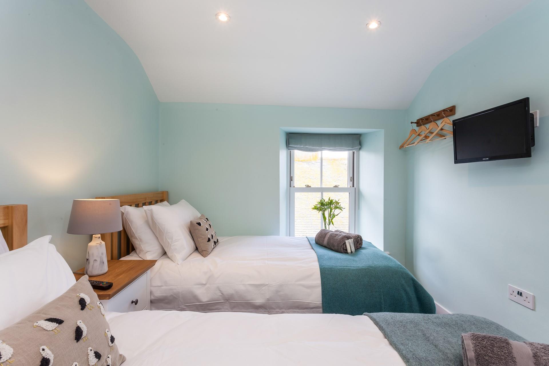 Seaside blues create a calming space to relax in bedroom 2.