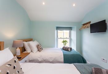 Seaside blues create a calming space to relax in bedroom 2.