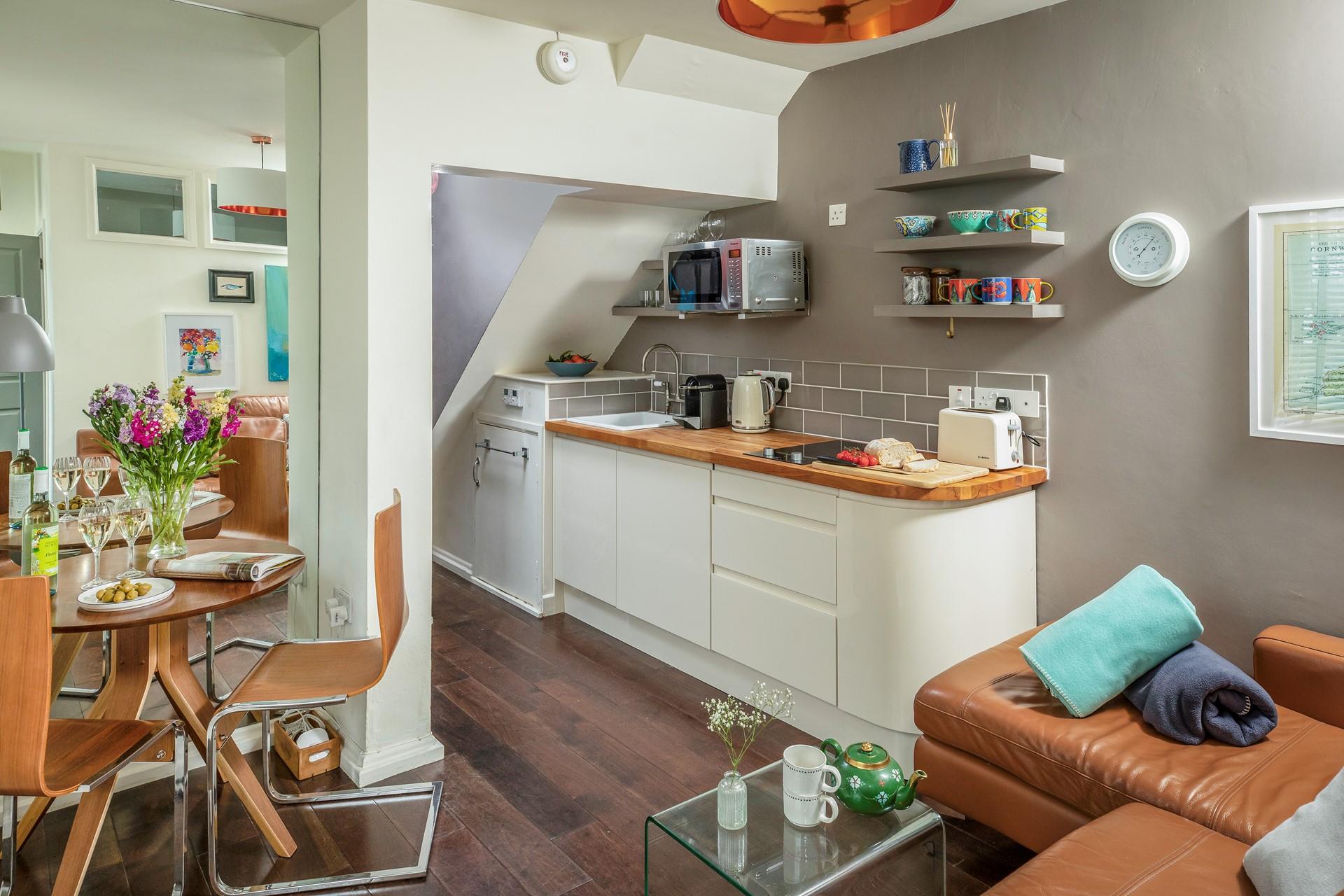 Mixing neutrals with splashes of colour and texture, the kitchen has been carefully designed.