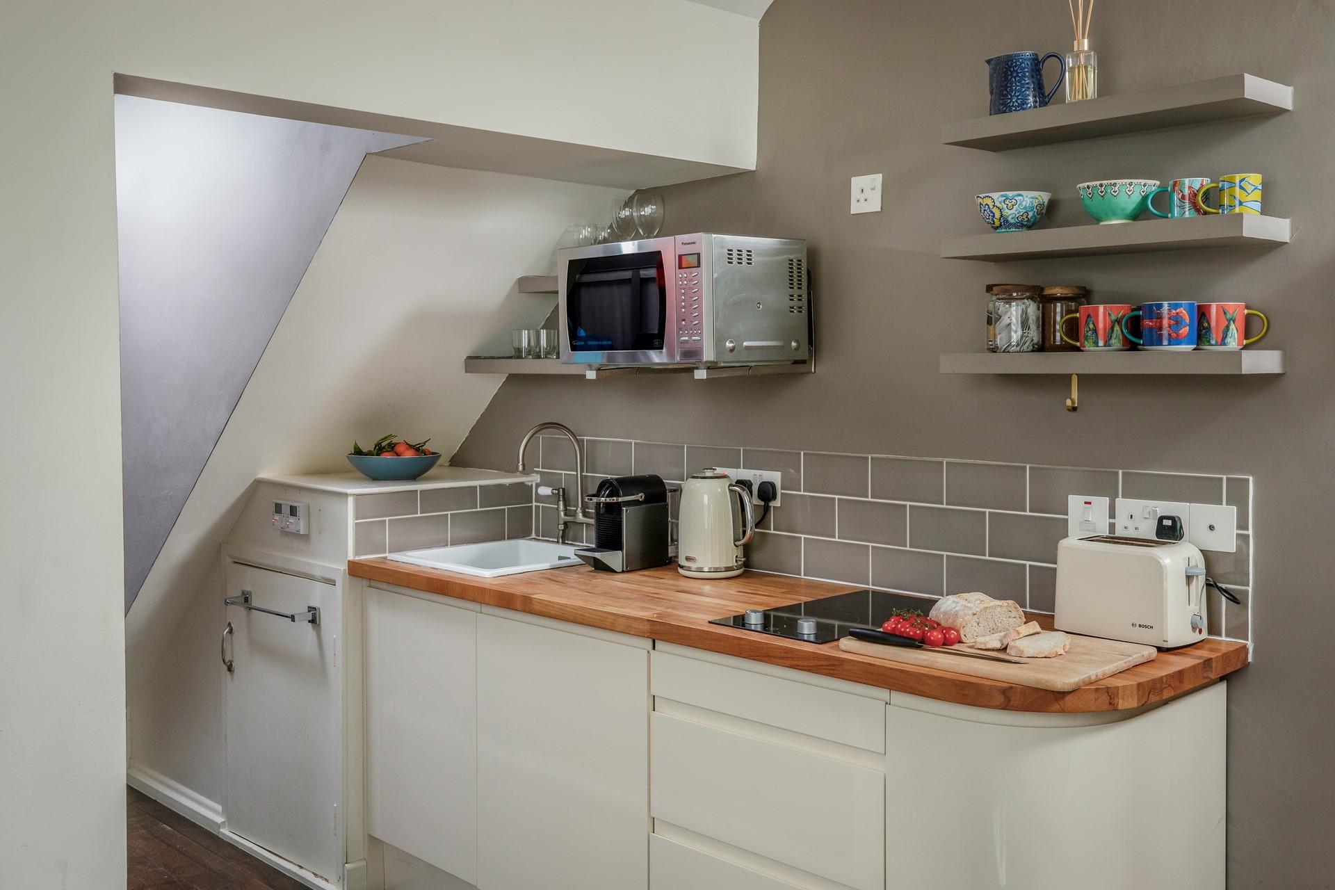Compact, yet well-equipped the kitchen is fabulous for whipping up home-cooked meals.