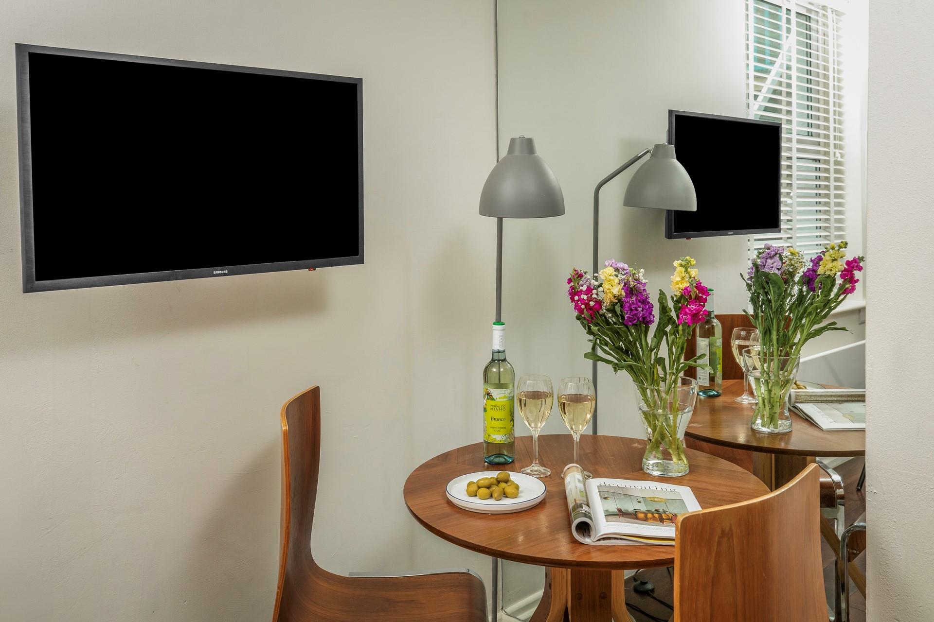 The stylish dining table offers a cosy space for two to enjoy dinner together.