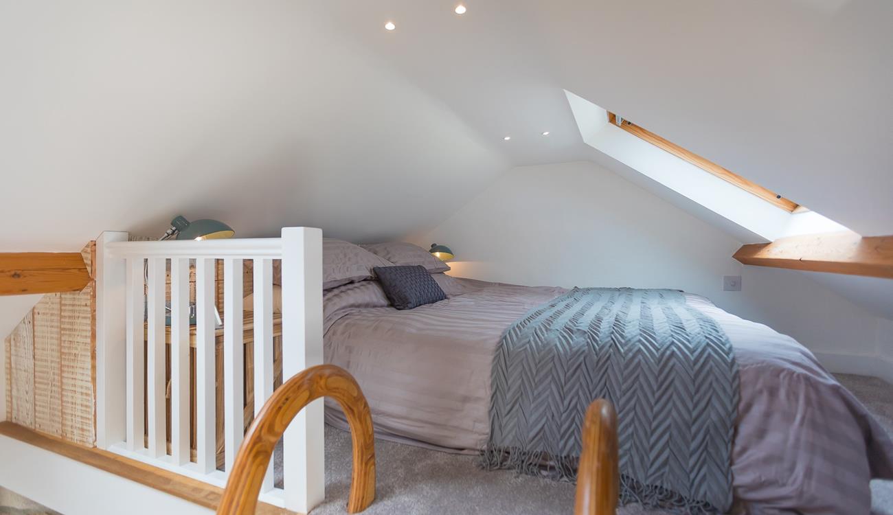 A ladder from the landing leads to the cosy mezzanine level with a double bed.