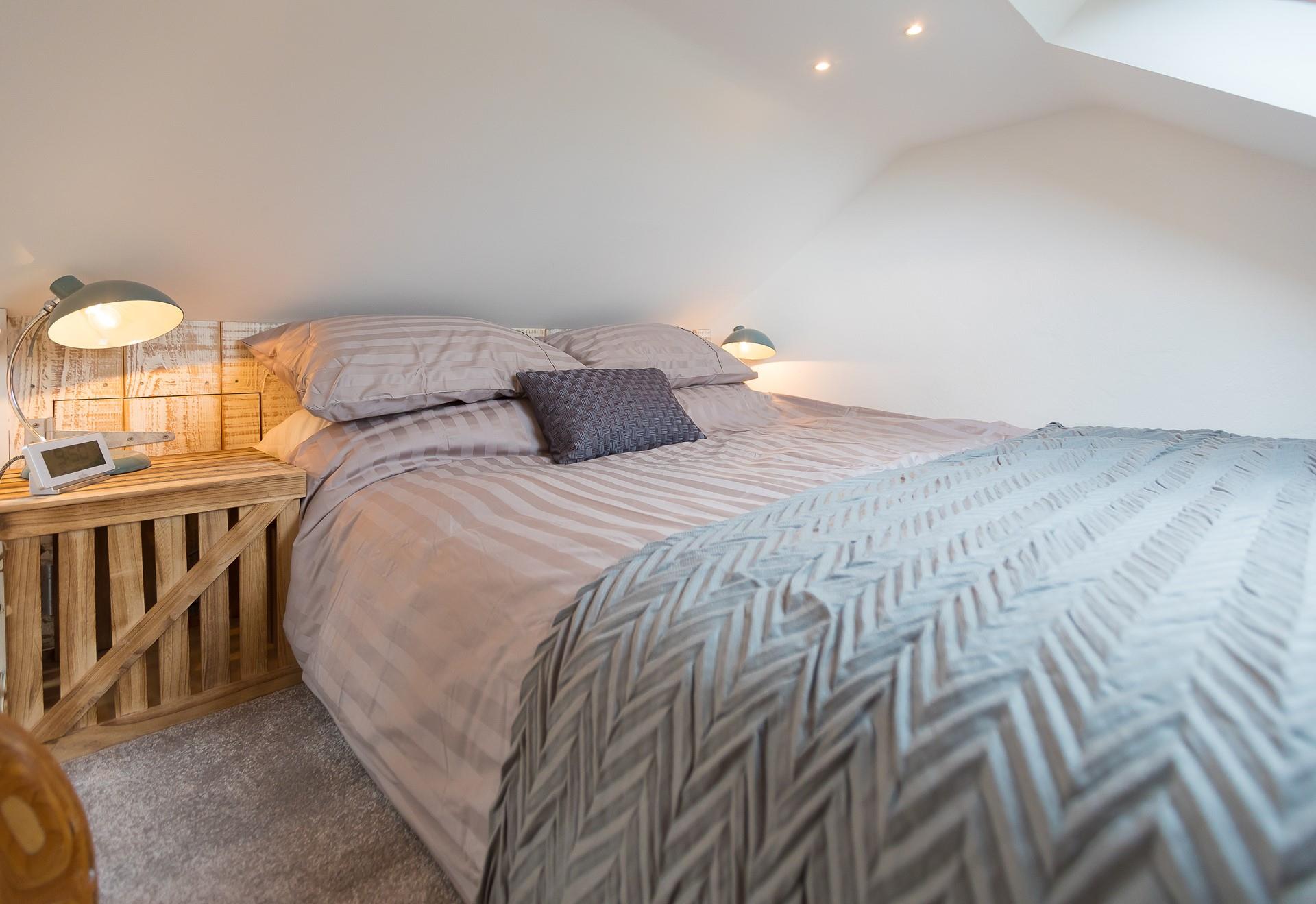 We love the natural, rustic-looking wall and stylish bedside table. 