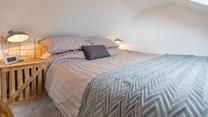 We love the natural, rustic-looking wall and stylish bedside table. 