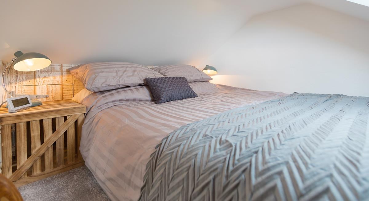 We love the natural, rustic-looking wall and stylish bedside table. 