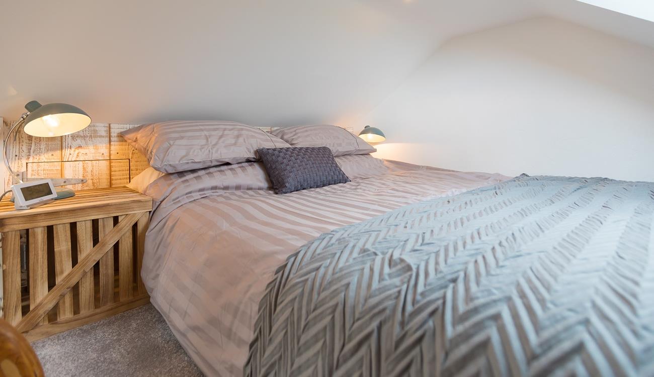 We love the natural, rustic-looking wall and stylish bedside table. 